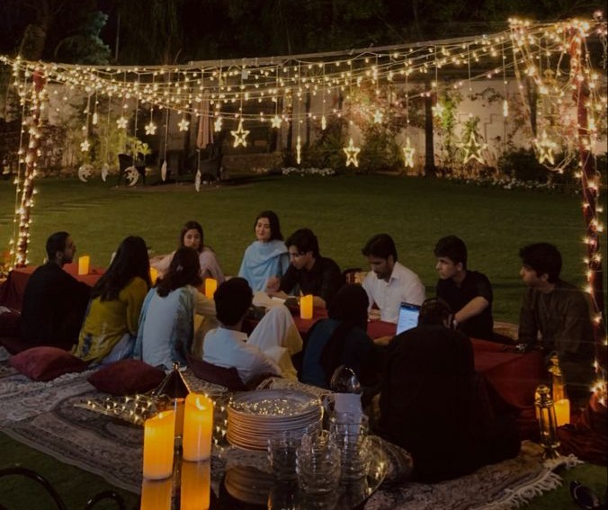 Intimate evening gathering under string lights at Gala farmhouse venue